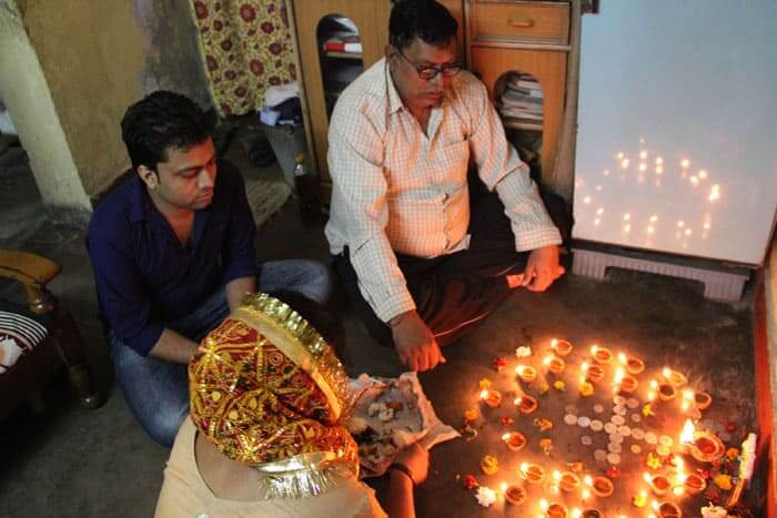 A family performing Puja (prayers) for the Diwali festival. Special prayers are held during the four day festival.