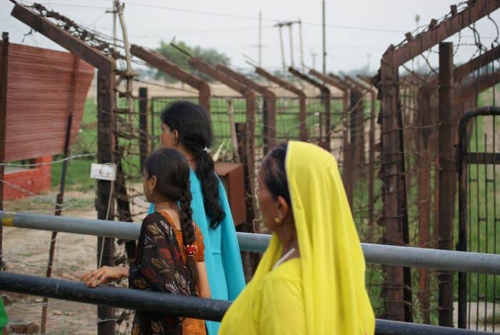 Women wait at an India-Pakistan border crossing