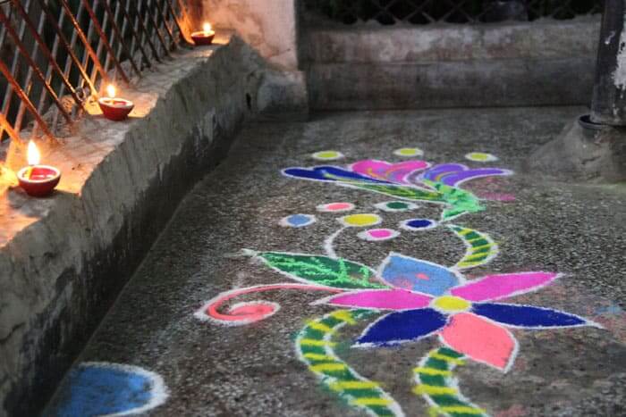 Rangoli is a colourful pattern made from dyed powders and flowers to welcome the goddess Lakshmi.